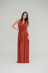 Vestido largo color fucsia, con escote halter y lazo en la cintura.