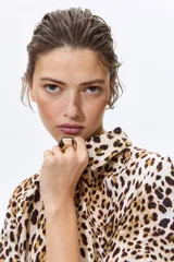 Vestido midi con cuello camisero, botonadura frontal y mangas cortas, con estampado de leopardo, elástico en la cintura y cinturón extraíble para atar.