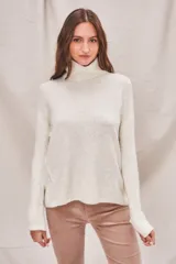 Sweater de punto color crema, con cuello alto y mangas largas.