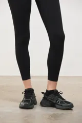 Calza deportiva de tiro alto con diseño sin costuras en el frente, confeccionada en tejido suave y elastizado de compresión media.