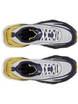 Championes de running Under Armour modelo Halo Racer, con diseño técnico en colores blanco, azul marino y amarillo. Presentan una entresuela con tecnología HOVR+ de gran amortiguación y geometría de balancín, parte superior de malla transpirable y suela de goma duradera para mayor tracción.