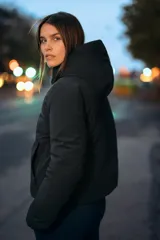 Anorak de corte corto y diseño minimalista, color negro. Cuenta con capucha integrada, cierre frontal con cremallera termosellada, bolsillos laterales con cierre y puños interiores elásticos. Posee acolchado interior y propiedades resistentes al agua y al viento.