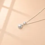 Collar de cadena fina con dije de esfera pequeña con acabado texturizado martillado, elaborado en plata 925.