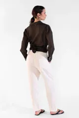 Camisa de manga larga color marrón, con cuello camisero, botones frontales nacarados y tiras cruzadas en la cintura.