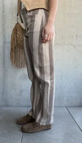 Jean de tiro medio con diseño de rayas verticales en tonos beige y marrón, corte recto y con elastano.