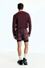 Remera deportiva de manga larga color bordó, con cuello redondo y tejido funcional con textura microperforada.