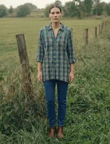 Camisa de manga larga con estampado de cuadros en tonos verde, azul marino y amarillo. Presenta un canesú bordado en la parte superior del pecho y hombros con diseño geométrico en tonos verdes y blancos.