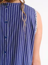 Vestido largo sin mangas, de corte amplio y relajado, con estampa a cuadros, escote redondo y falda fruncida. Cuenta con detalles de costura a contratono en las sisas y logo frontal.