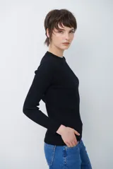 Buzo de tejido morley color marrón, con cuello redondo y mangas largas, de corte ajustado al cuerpo.