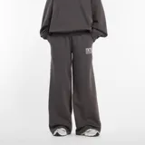 Pantalón de jogging New Balance de corte relajado y amplio, con tiro alto, cintura elástica y bolsillos laterales. Presenta el logo de la marca estampado en la parte frontal.