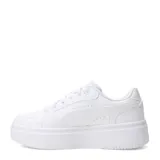Championes Puma modelo Rebound Femme Low con plataforma, diseño monocromático en color blanco, con perforaciones en los laterales y puntera, y logo de la marca en el talón de la suela.