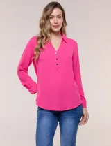 Blusa fucsia de calce holgado y caída fluida, confeccionada en tejido tipo crepé. Presenta cuello camisero con escote en V, cierre parcial al frente con tres botones metálicos y mangas largas ajustables con presilla.