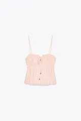Top color rosa claro confeccionado con lino. Presenta escote recto con cordón ajustable con abalorios y tirantes finos. Detalle de acabados elásticos y frunces.