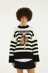 Sweater de punto con diseño a rayas horizontales blancas y negras, cuello alto y puños anchos. Cuenta con un bordado frontal en el centro que representa un loro sobre hojas tropicales y el texto "Farm Rio".