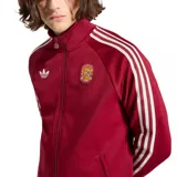 Campera deportiva Adidas de la selección de España, color bordó con cierre frontal, cuello alto y las icónicas tres tiras blancas en las mangas. Presenta el logo de Adidas Originals en el pecho derecho y el escudo de la selección en el pecho izquierdo.