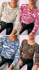 Remera de manga larga con cuello redondo y estampado de cebra en colores verde, rojo, azul y marrón.