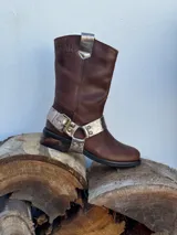 Bota de cuero marrón con estribo desmontable plateado.