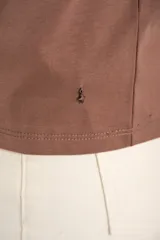 Remera de algodón peinado color blanco, con escote en V y detalles de lurex dorado en el borde del escote. De manga corta y corte ajustado.