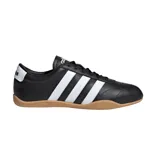 Championes Adidas de estilo tenis, color negro con tres franjas laterales blancas y talón blanco con logo. Suela de goma color caramelo.