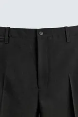 Pantalón de corte regular fit confeccionado en lana de origen italiano. Presenta bolsillos laterales, bolsillo cerillero frontal, bolsillos traseros de vivo y cierre frontal con cremallera y botón.