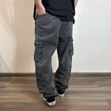 Jean cargo de corte baggy en color azul lavado, con múltiples bolsillos laterales tipo cargo y cierre frontal.