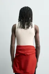 Camiseta sin mangas de corte regular, confeccionada en tejido de algodón con elasticidad. Presenta un diseño de rayas horizontales finas, cuello redondo y acabados en vivo doble.