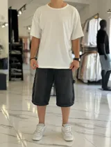 Bermuda de jean estilo carpintero, color celeste, con bolsillos laterales amplios, presilla para herramientas y diseño amplio de corte oversize.