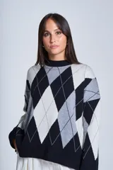 Sweater de punto con diseño de rombos en tonos beige y blanco, cuello redondo y corte holgado.