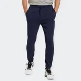 Pantalón de jogging azul marino de corte ajustado, con cintura elástica ajustable con cordón y bolsillos laterales. Logo de Reebok bordado en blanco en la pierna izquierda.