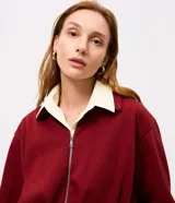 Campera corta en algodón con felpa color bordó, de diseño baloné con cierre frontal metálico y cuello clásico.