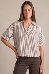 Camisa de corte oversize, con diseño de rayas verticales en tonos marrón y blanco, cuello camisero, escote en V con cierre frontal de botones y mangas cortas holgadas.