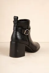 Botas de caña baja color negro, con taco cuadrado, punta fina y detalle de tira con textura de piel de reptil y hebilla metálica.