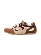 Sneaker urbano confeccionado en mix de cueros y texturas en tonos marrón, beige y bordó, con cordones combinados y suela dentada de goma.