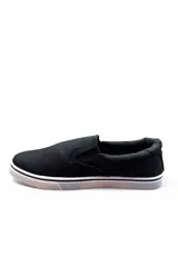 Mocasines tipo slip-on de lona color azul marino con suela blanca de goma y elásticos laterales para facilitar el calce.