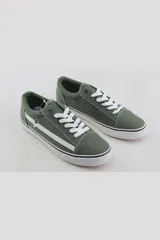 Championes urbanos de estilo skate, color negro con detalles en blanco. Presentan una franja lateral blanca distintiva, cordones blancos y suela de goma vulcanizada blanca.