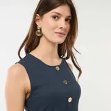 Musculosa azul marino con cuello redondo y cierre frontal de botones dorados grandes con diseño texturizado.