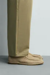 Zapato de cordones de hombre confeccionado en piel con acabado serraje en color beige, con detalle de bordón en el empeine, horma redonda y suela a contraste.