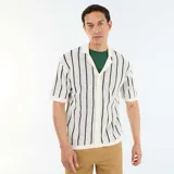 Camisa de manga corta de punto calado en color beige con rayas verticales negras, cuello tipo polo y cierre frontal con botones.