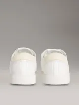 Zapatillas de perfil bajo Calvin Klein en piel color blanco, con suela cupsole de caucho y detalle de monograma grabado en el lateral.