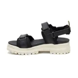 Sandalias Caterpillar modelo Second Chance para mujer, en color negro con suela gruesa track color marfil. Presentan tiras anchas con ajuste de velcro y detalles de la marca en amarillo.