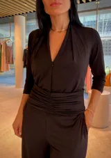 Mono largo color rojo, con escote en V, mangas 3/4 y detalle de faja fruncida en la cintura. Incluye bolsillos laterales.