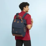 Mochila Cabaia modelo Adventurer Chicago, color azul con detalles en marrón. Tiene capacidad de 12L, 23L o 26L, sistema MOLLE, compartimento acolchado para tablet o PC, correa para sujetar a la maleta y tirantes acolchados antitranspirantes.