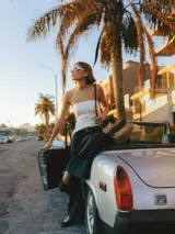 Top strapless blanco con frunces y calce ajustado.