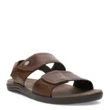 Sandalias de cuero color marrón con diseño de dos tiras anchas ajustables mediante velcro y talón cerrado. Poseen suela de goma ergonómica y detalle de logo metálico en la tira superior.