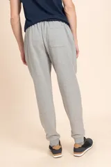 Pantalon deportivo tipo jogger en color gris melange, con cintura elastizada y puños en los tobillos. Cuenta con un bolsillo trasero aplicado.