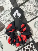 Coletero negro con estampado de nubes rojas, inspirado en el anime Naruto.