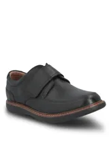 Zapato de cuero negro con cierre de velcro, suela de goma EVA flexible y diseño ergonómico.