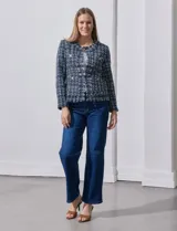 Blazer azul marino de tejido tweed con cuello a la base, apertura central y bolsillos delanteros. Puños con aplique de botones metálicos y terminación desflecada. Forro interno.