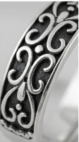 Anillo de banda ancha fabricado en plata 925, con diseño labrado de filigrana en relieve con acabado oxidado.