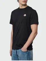 Remera de algodón de corte clásico, color negro, con cuello redondo y logo de la marca aplicado en el pecho.